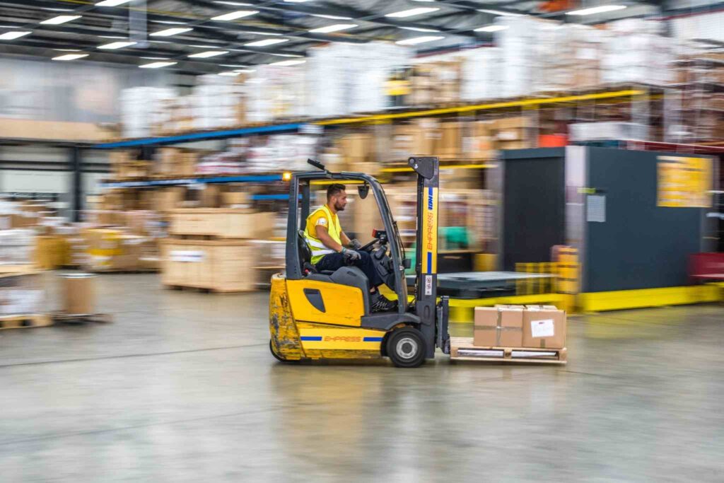 Men on moving material handling equipment