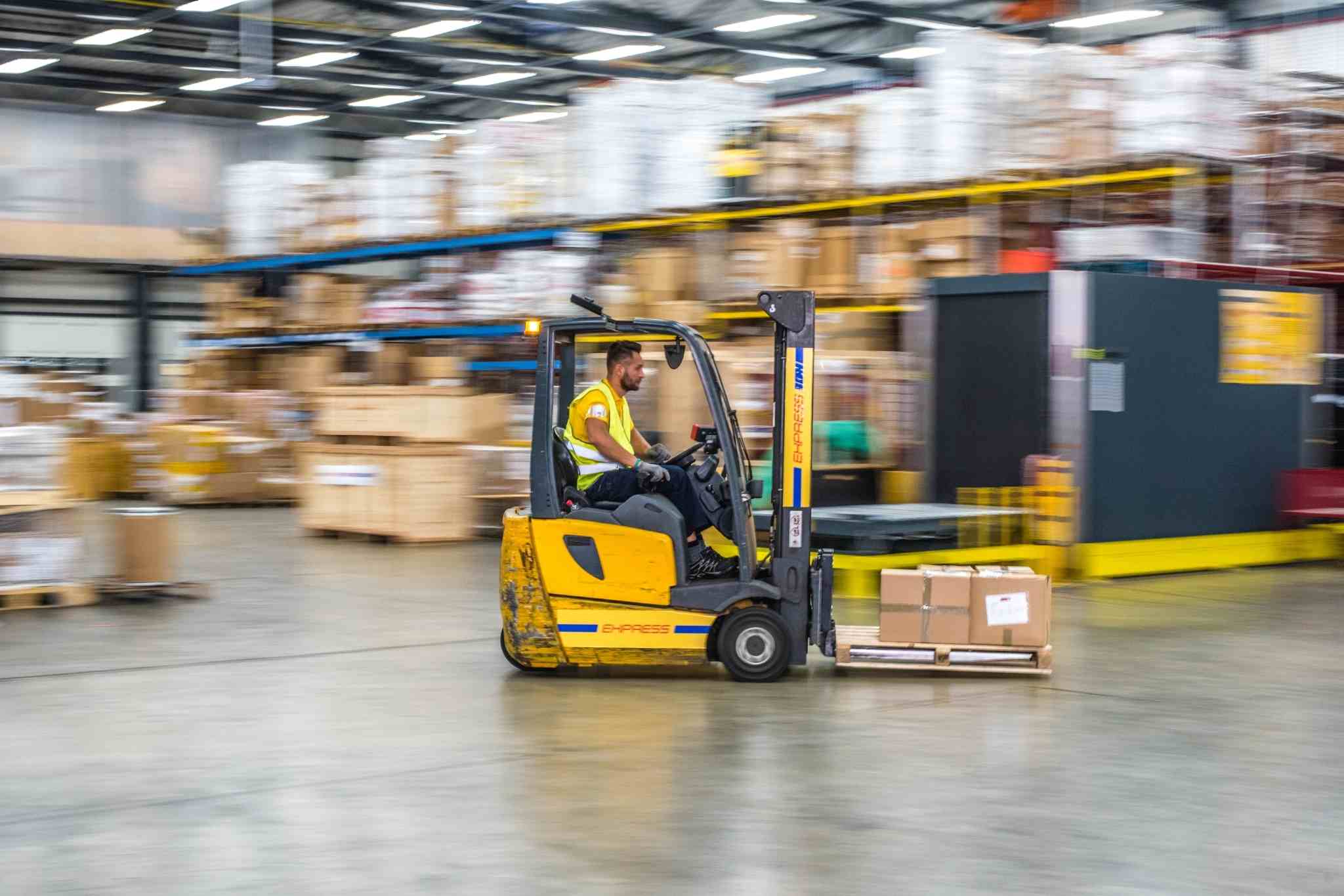 Men on moving material handling equipment