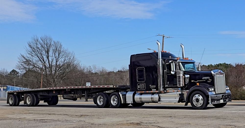 Black semi with flatbed for Conestoga use.