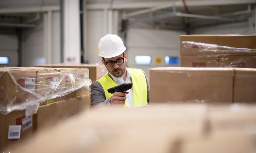Warehouse personnel checking inventory through RFID Scanning
